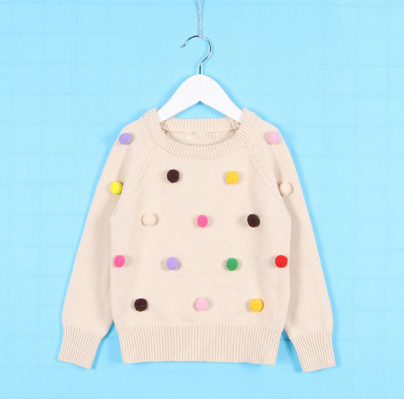 Chaleco con pompones de varios colores