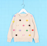Chaleco con pompones de varios colores