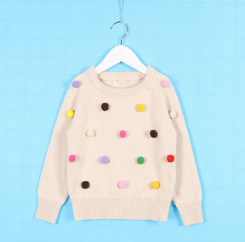 Chaleco con pompones de varios colores