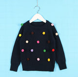 Chaleco con pompones de varios colores