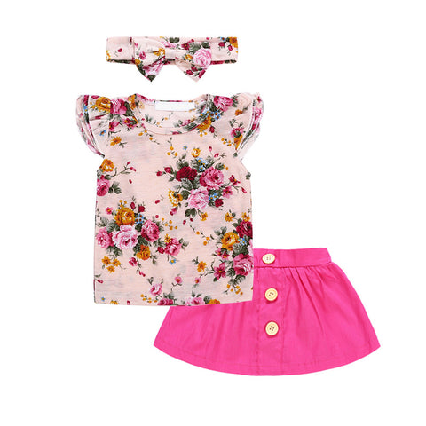 Conjunto tres piezas, falda fucsia con botones, polera floreada y cintillo misma tela