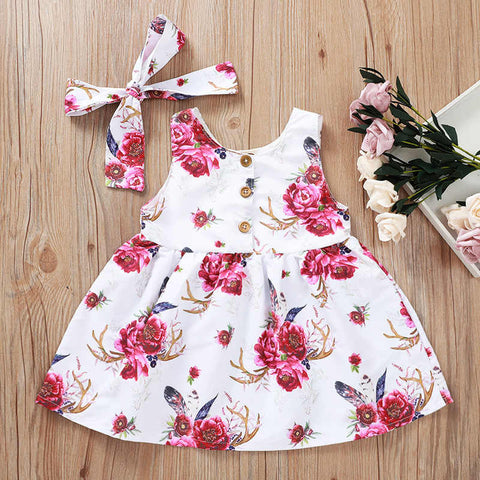 Precioso y femenino vestido abotonado y flores fucsias, incluye lazo de igual tela